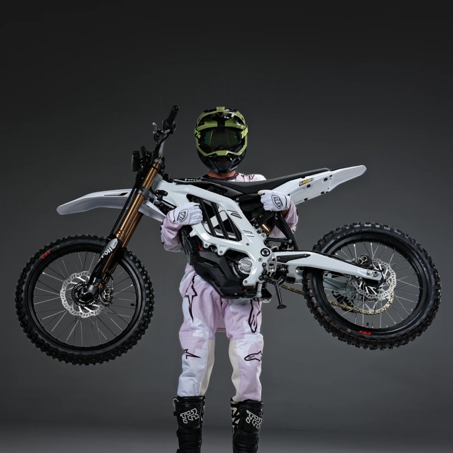 Rider standing next to a Surron Light Bee